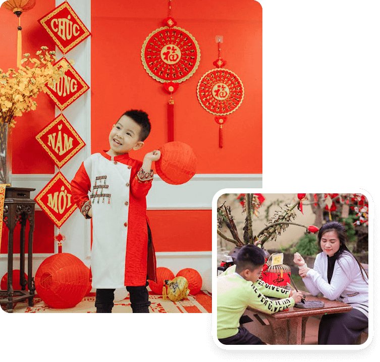 A boy in an apron and two women hanging decorations